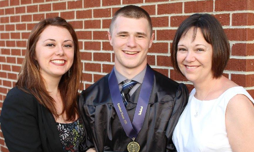 Cameron Adamson at graduation with his mother and sister